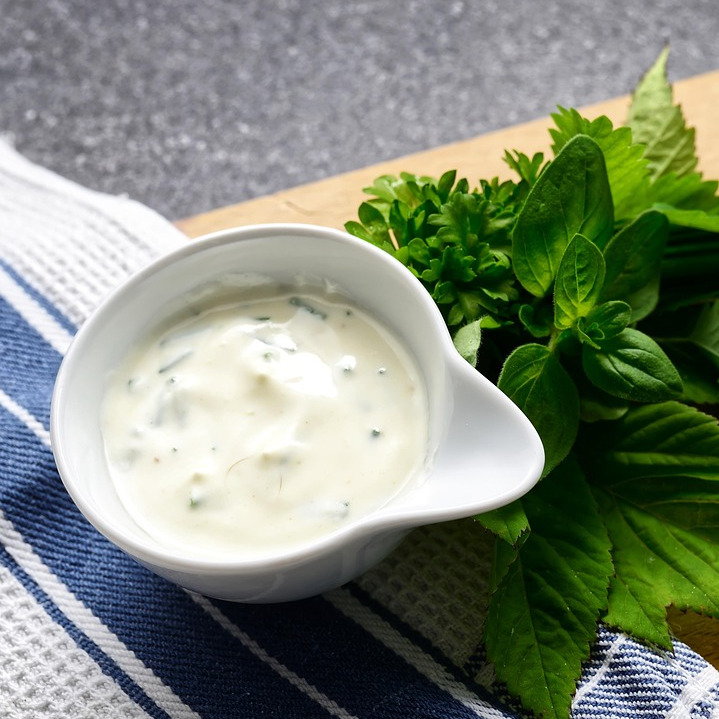 woman cooking salad in kitchen
